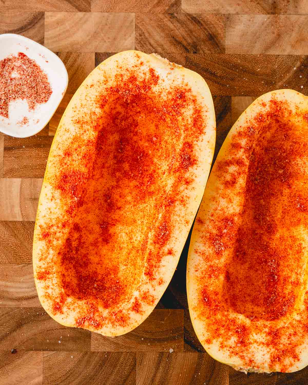 Spice mixture sprinkled on top of the spaghetti squash halves.