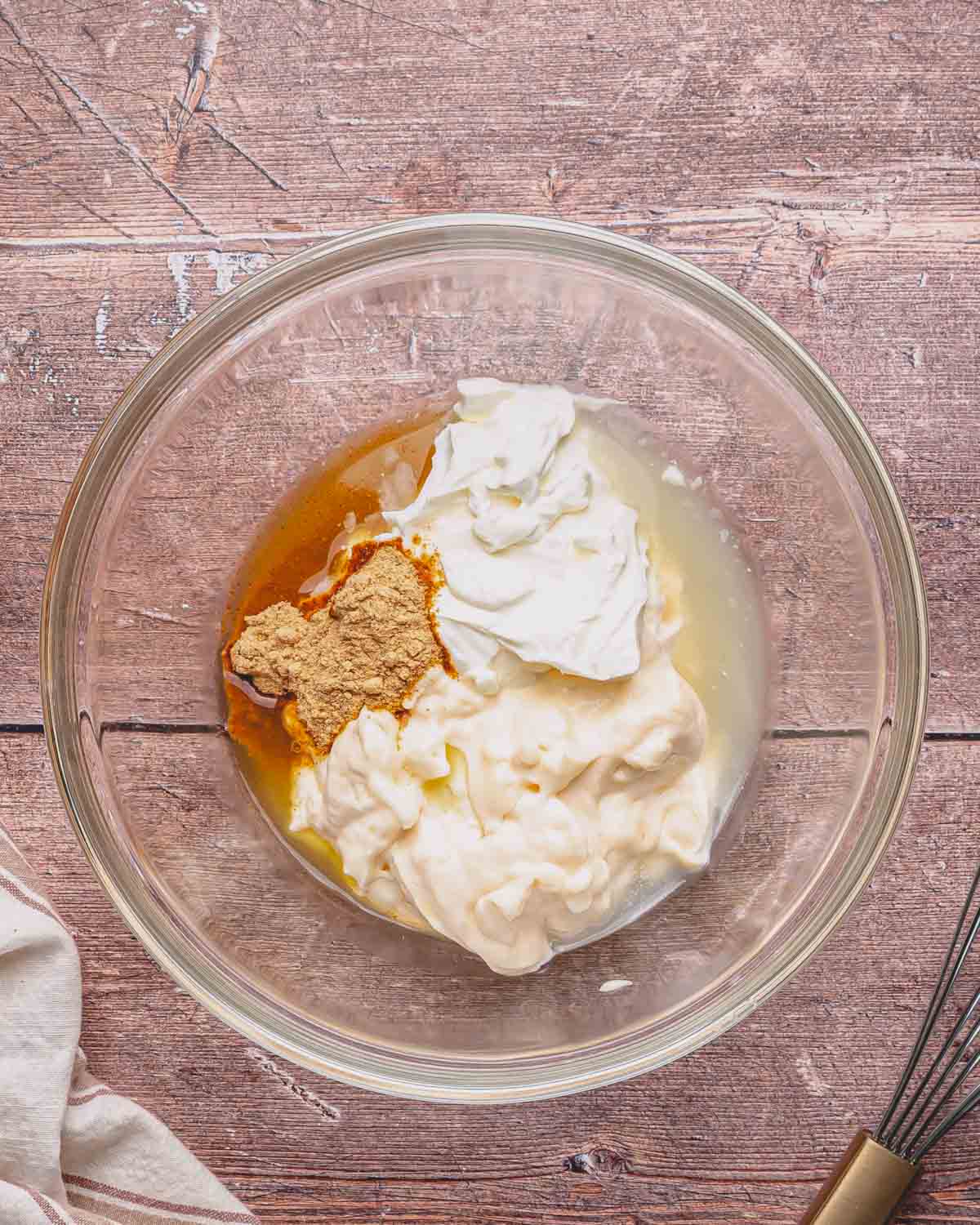A glass bowl with the sauce ingredients for Mexican chicken salad.