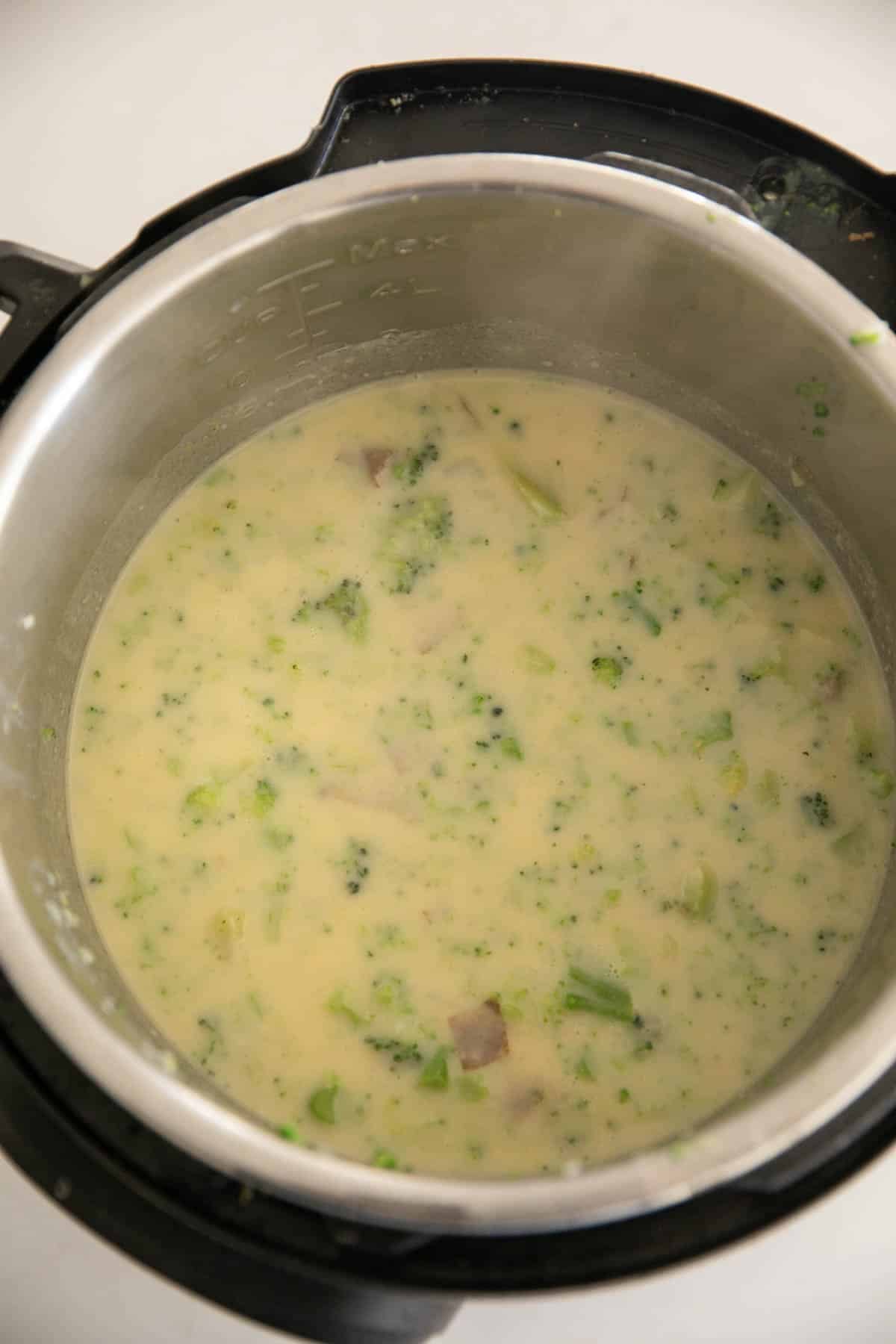 An Instant Pot with Broccoli Potato cheddar soup.