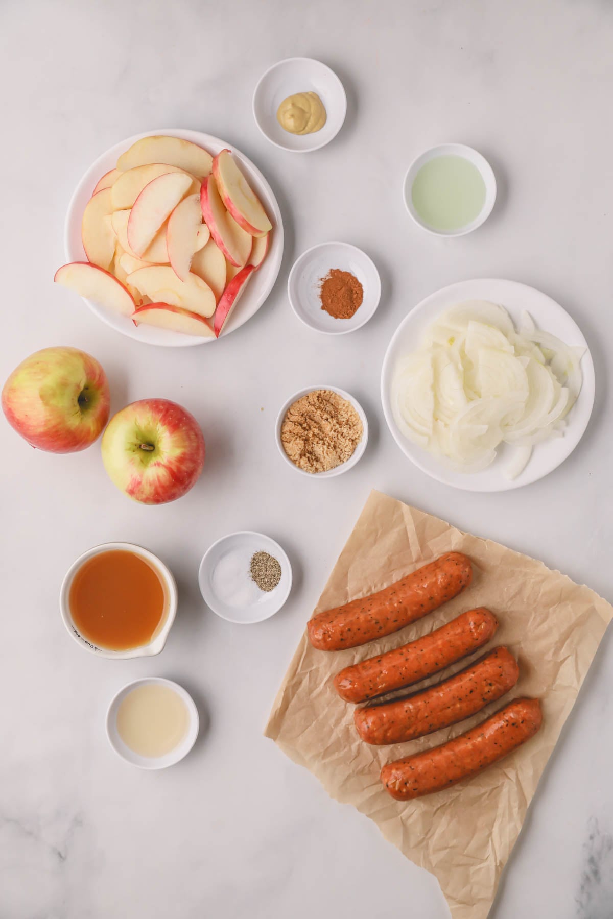 Ingredients for chicken sausage and apples.
