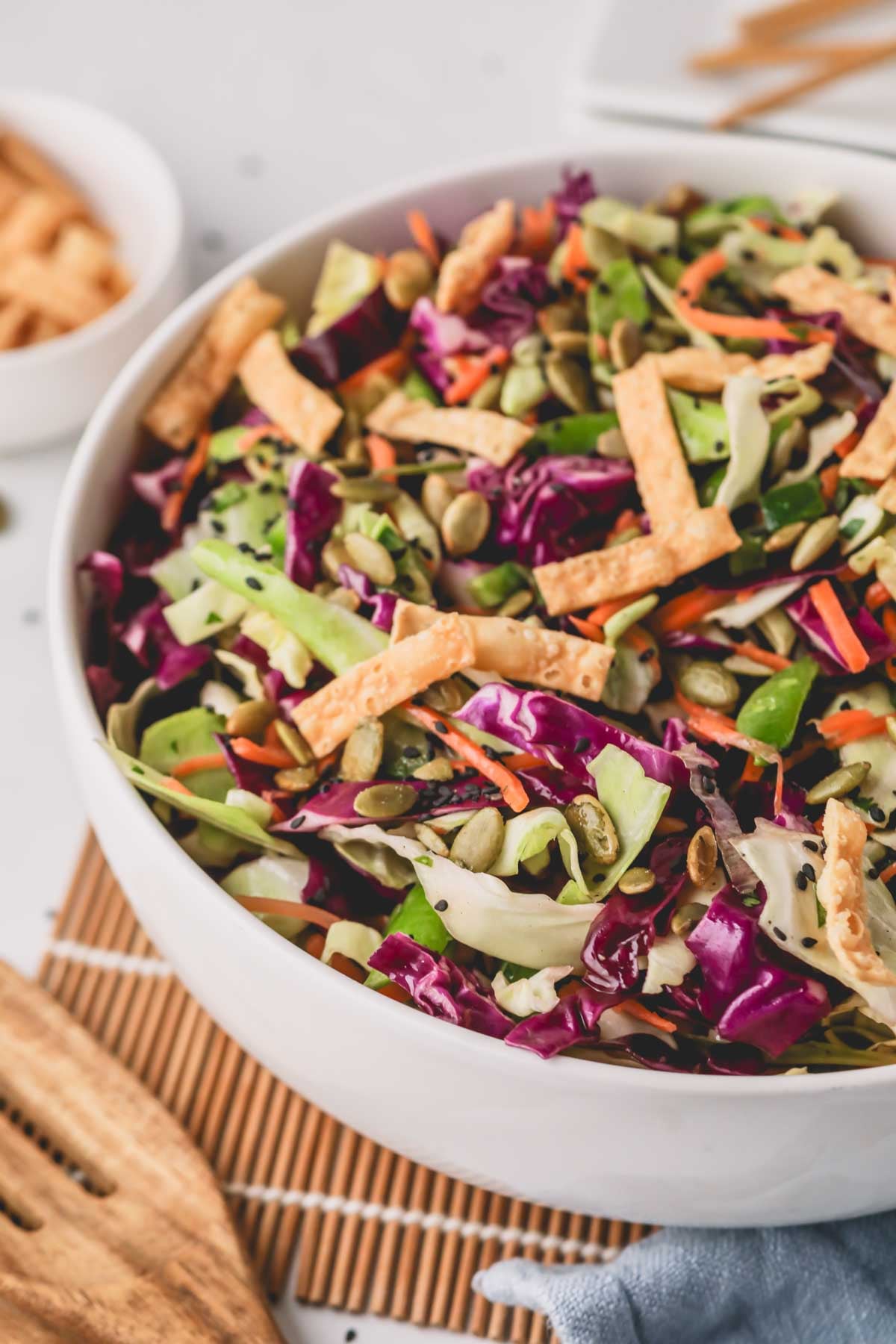 A white bowl with crunchy Asian coleslaw.