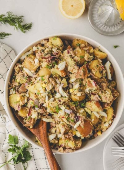 White bowl of tuna potato salad.